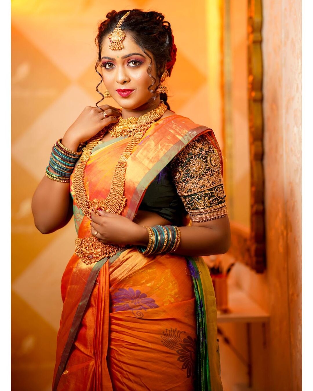 Classic South Indian bridal look in orange silk saree